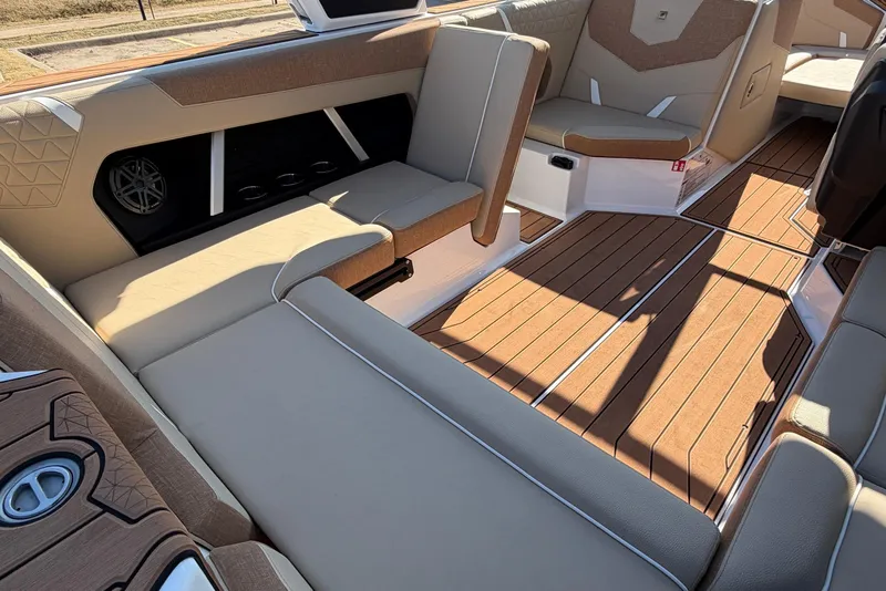 Slide: The Image of 2026 Nautique Super Air Nautique GS22 interior with tan seating and teak-style flooring. - 34