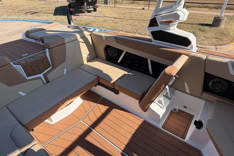 Slide: The Image of 2026 Nautique Super Air Nautique GS22 interior with tan seating and teak flooring. - 35
