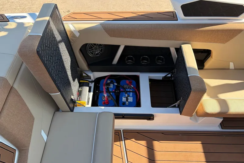 Slide: The Image of 2026 Nautique Super Air Nautique GS22 interior with open storage compartments and visible battery setup. - 38