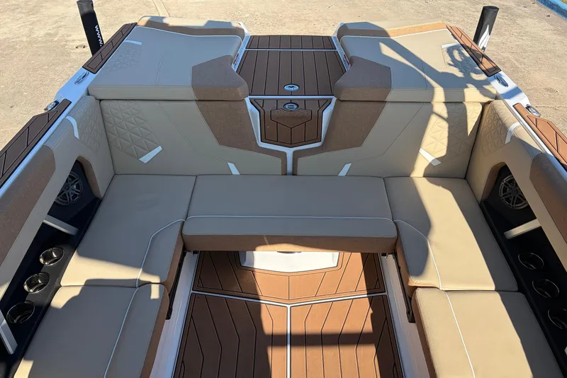 Slide: The Image of 2026 Nautique Super Air Nautique GS22 interior with tan seating and wood accents. - 39