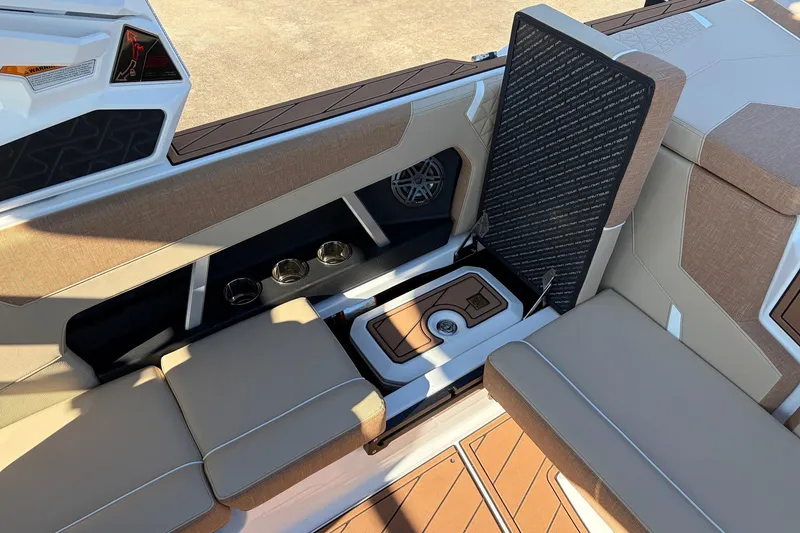 Slide: The Image of 2026 Nautique Super Air Nautique GS22 interior with seating and storage compartment. - 42