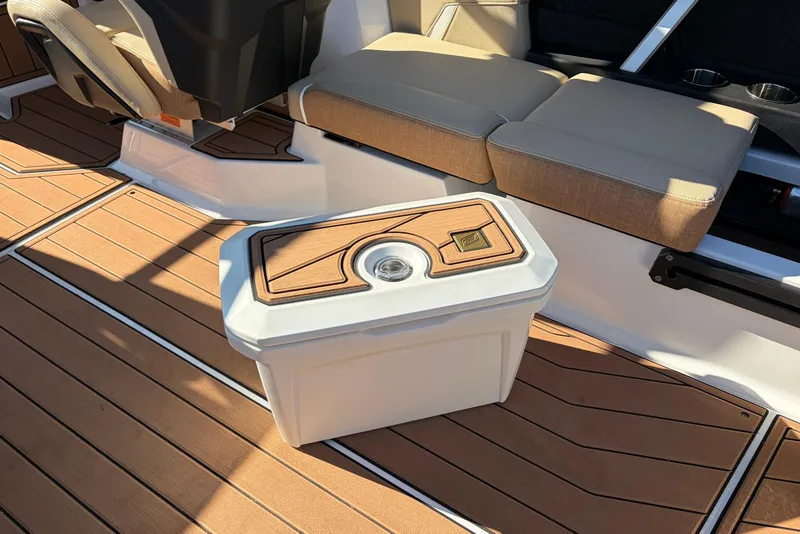 Slide: The Image of 2026 Nautique Super Air Nautique GS22 interior with cushioned seating and stylish deck flooring. - 43