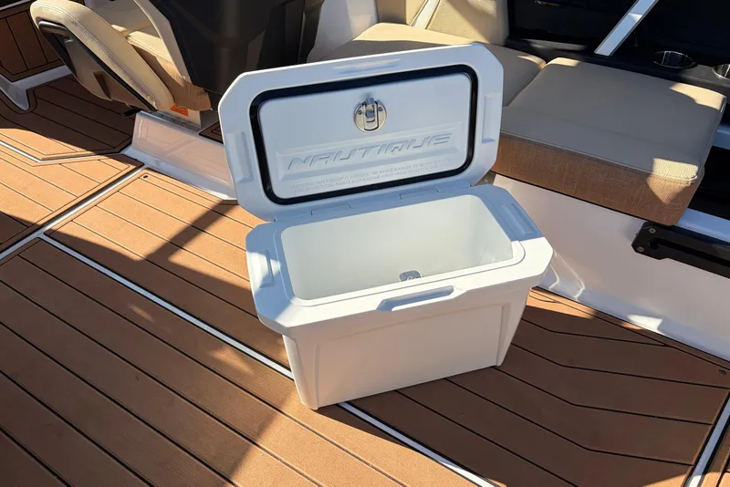 Slide: The Image of Open cooler on 2026 Nautique Super Air Nautique GS22 boat deck. - 44