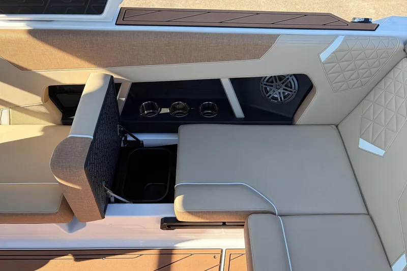 Slide: The Image of 2026 Nautique Super Air Nautique GS22 interior seating with cup holders and speaker. - 45