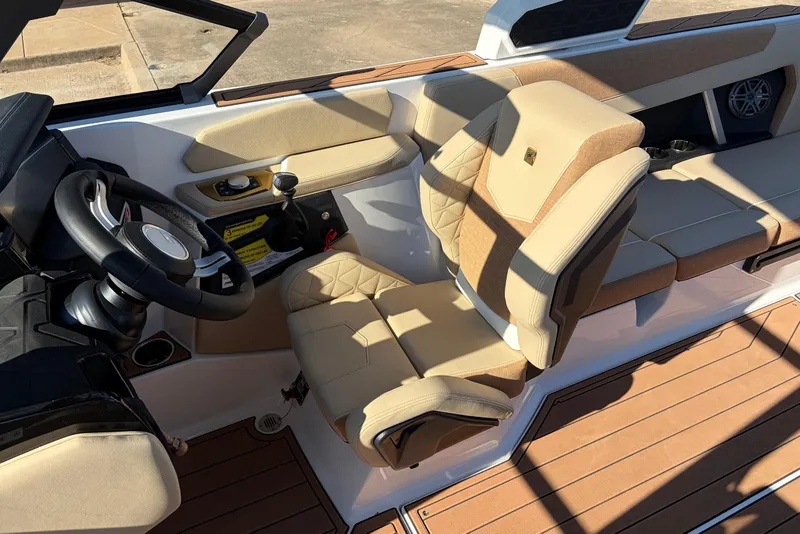 Slide: The Image of 2026 Nautique Super Air Nautique GS22 interior with beige seating and modern dashboard. - 50