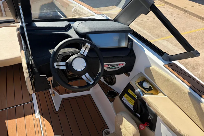 Slide: The Image of 2026 Nautique Super Air Nautique GS22 cockpit with modern steering and controls. - 52