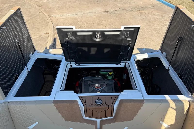 Slide: The Image of 2026 Nautique Super Air Nautique GS22 engine compartment with open hatches, showcasing storage space. - 59