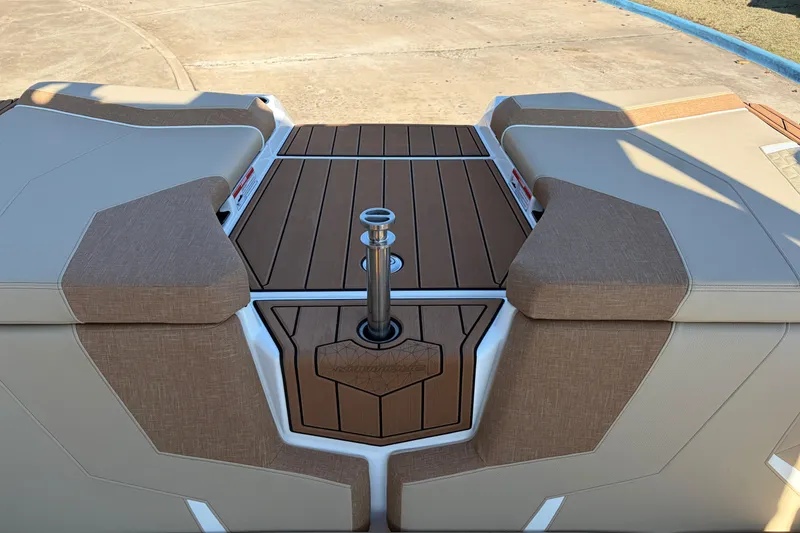 Slide: The Image of 2026 Nautique Super Air Nautique GS22 boat interior with tan seating and teak flooring. - 62