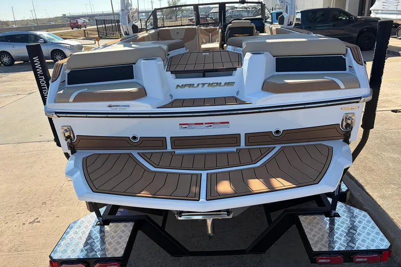 Slide: The Image of 2026 Nautique Super Air Nautique GS22 boat on trailer, rear view, in outdoor setting. - 68