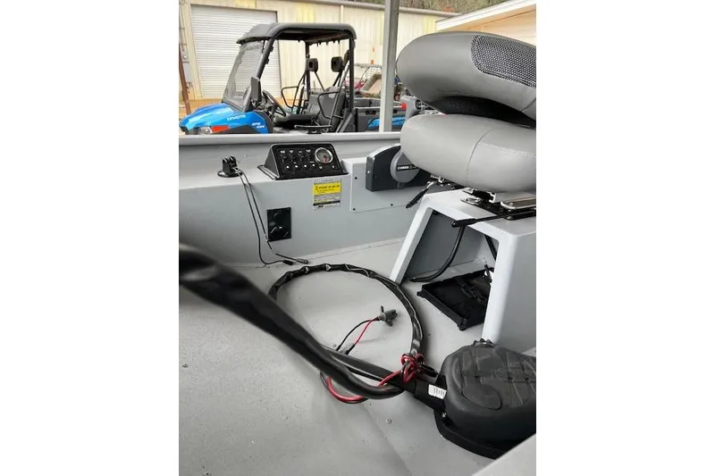 The Image of 2025 G3 Sportsman 1610 SS boat interior with seating and control panel. - 1