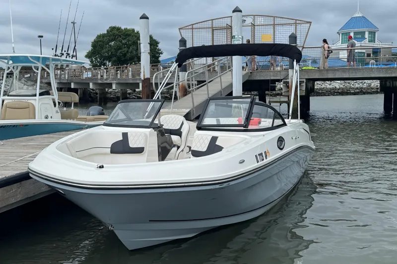 Slide: The Image of 2024 Bayliner VR6 Bowrider OB docked at marina, featuring sleek design and spacious seating. - 3