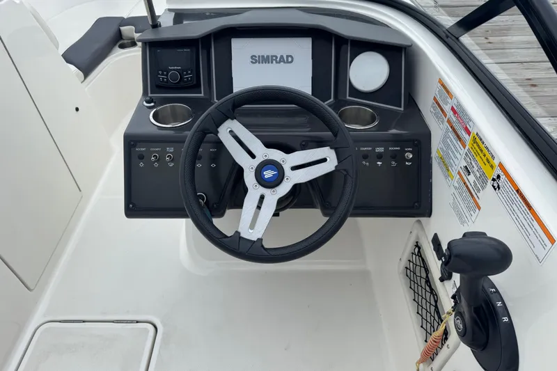 Slide: The Image of 2024 Bayliner VR6 Bowrider OB dashboard with steering wheel and control panel. - 4