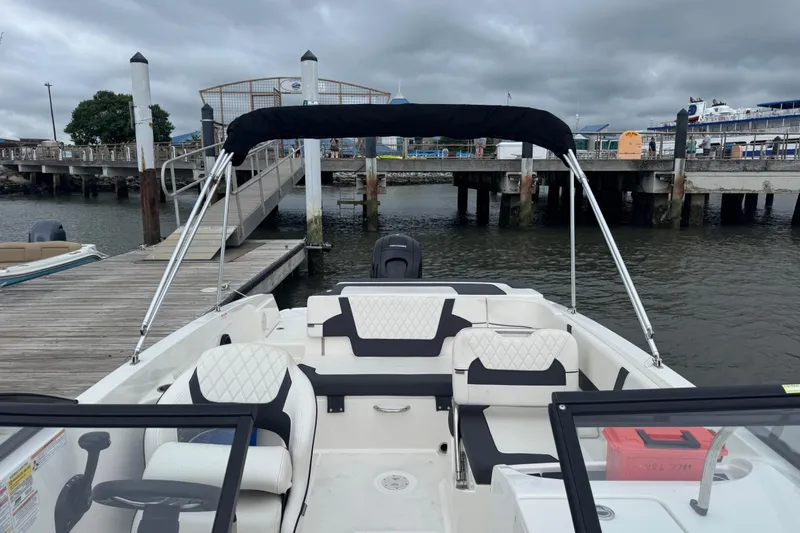 Slide: The Image of 2024 Bayliner VR6 Bowrider OB docked, featuring spacious seating and sleek design. - 5