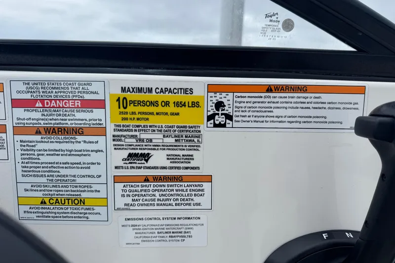 Slide: The Image of 2024 Bayliner VR6 Bowrider OB capacity and safety warning labels on dashboard. - 8