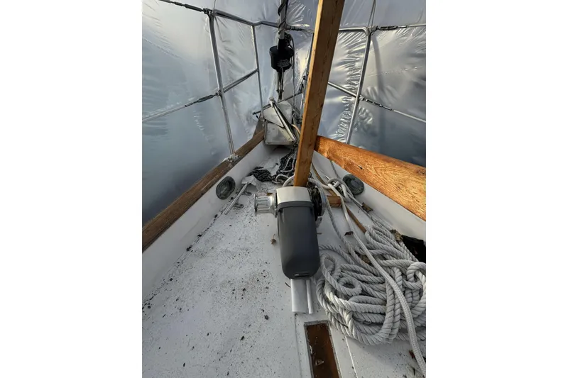 Slide: The Image of 1987 Irwin 38 sailboat deck with ropes and covered structure. - 10