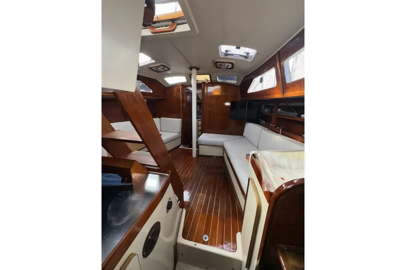 Slide: The Image of Interior of 1987 Irwin 38 sailboat with wooden finishes and white seating. - 20