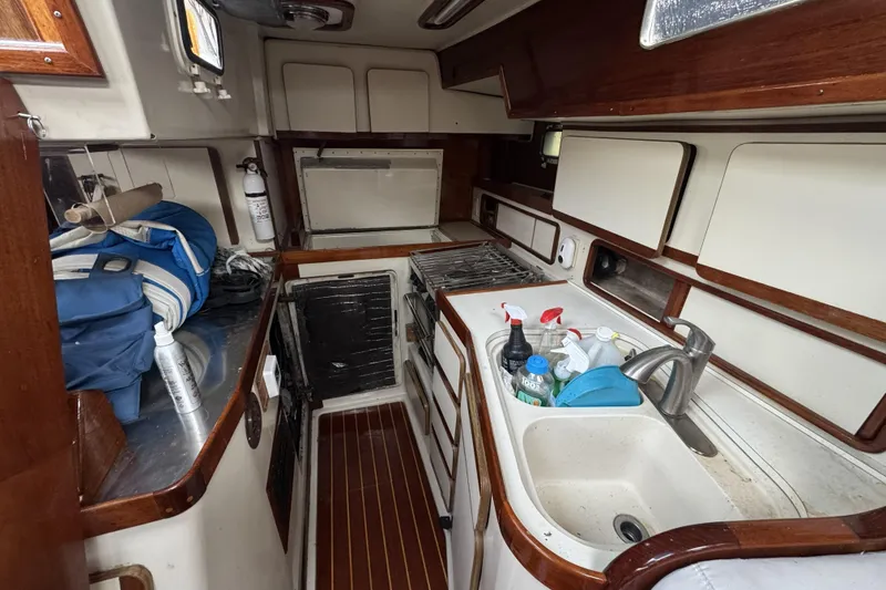 Slide: The Image of 1987 Irwin 38 yacht kitchen with sink, stove, and storage cabinets. - 22
