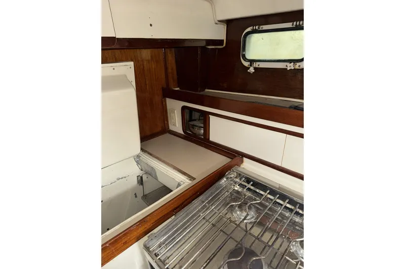 Slide: The Image of Interior of 1987 Irwin 38 sailboat kitchen with stove and wooden cabinetry. - 24