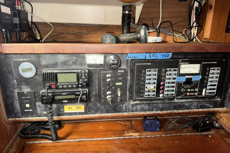 Slide: The Image of Electrical control panel on a 1987 Irwin 38 sailboat, featuring various switches and meters. - 26