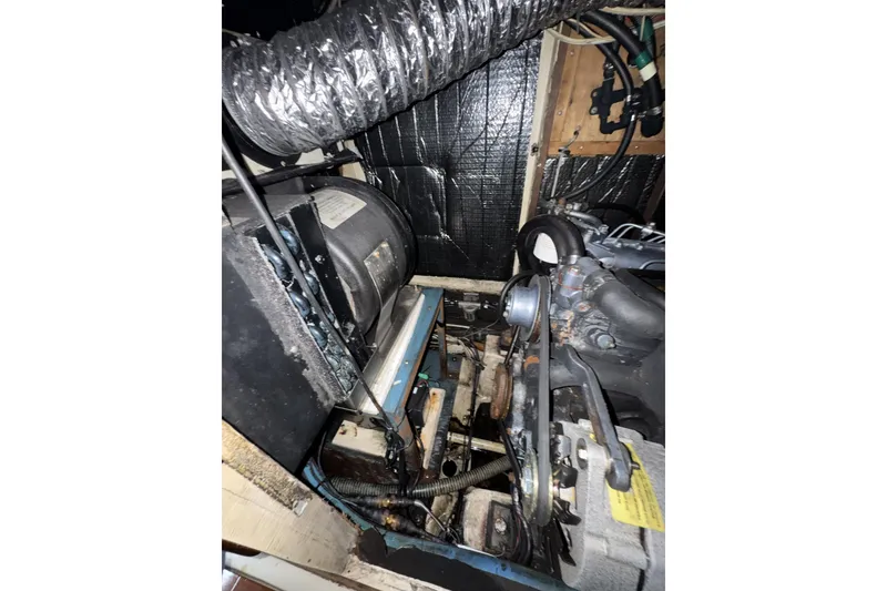 Slide: The Image of Engine compartment of a 1987 Irwin 38 sailboat, showing mechanical components and wiring. - 29