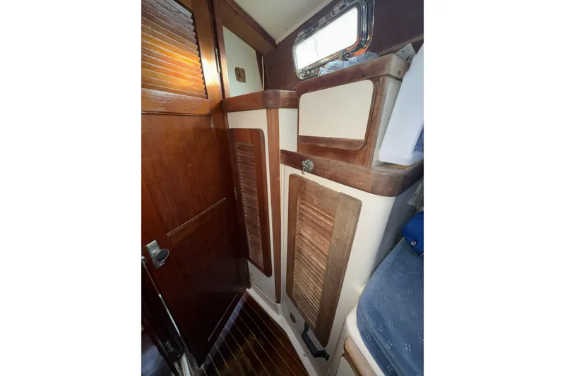 Slide: The Image of 1987 Irwin 38 yacht interior with wooden cabinetry and window. - 38