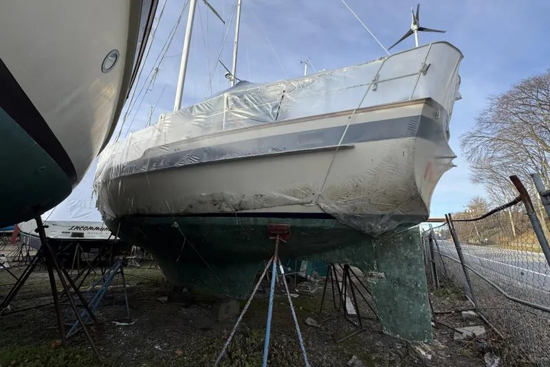 Slide: The Image of 1987 Irwin 38 sailboat in dry dock, covered with protective plastic wrap. - 4