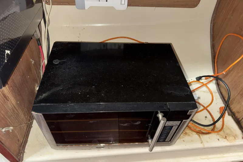 Slide: The Image of Old microwave in a 1987 Irwin 38 boat kitchen area. - 40