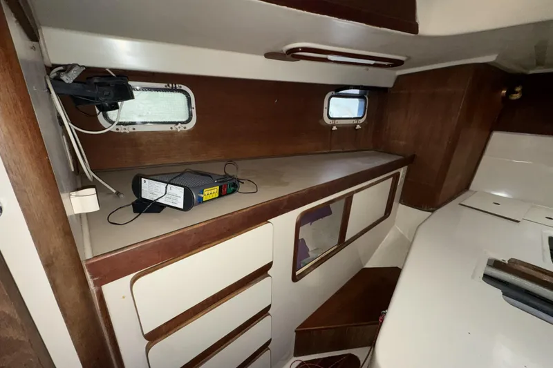 Slide: The Image of Interior of a 1987 Irwin 38 sailboat with wooden cabinetry and small windows. - 43