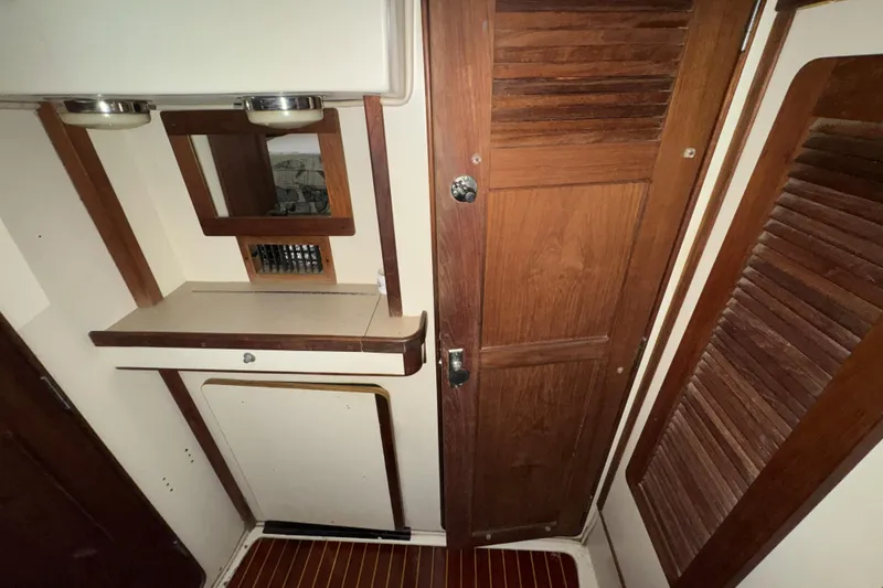 Slide: The Image of Interior of 1987 Irwin 38 sailboat with wooden cabinetry and mirror. - 44