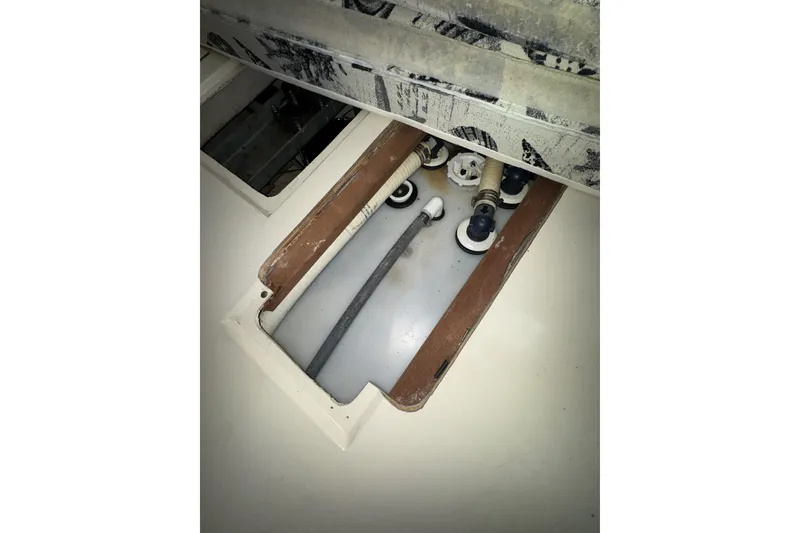 Slide: The Image of 1987 Irwin 38 yacht interior showing plumbing and storage compartment. - 47
