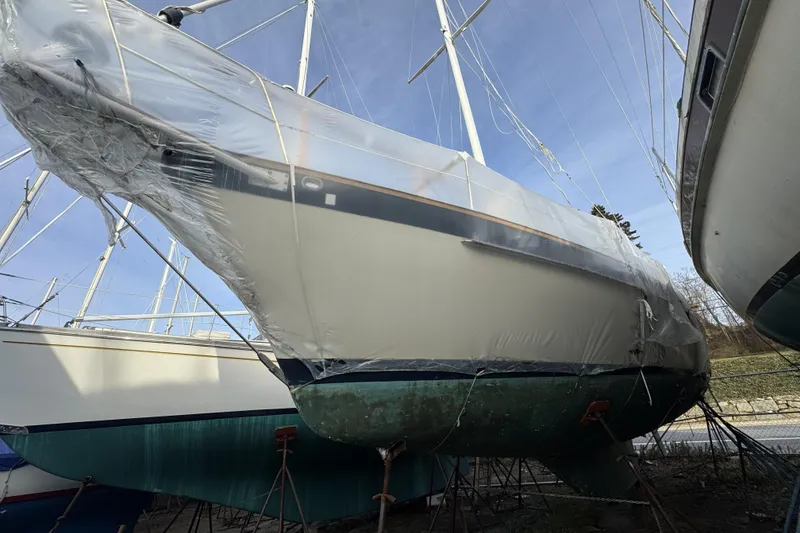 Slide: The Image of 1987 Irwin 38 sailboat wrapped in protective covering, stored on land. - 5