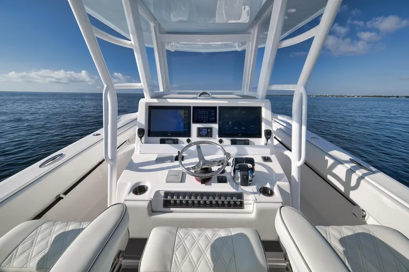Slide: The Image of 2022 Invincible 39 Open Fisherman boat cockpit with modern navigation system on calm ocean. - 23