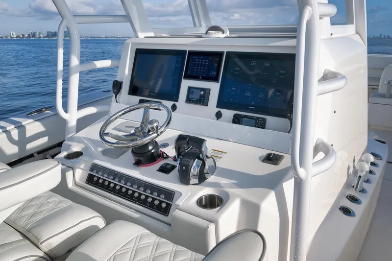 Slide: The Image of 2022 Invincible 39 Open Fisherman boat cockpit with modern controls and navigation screens. - 25