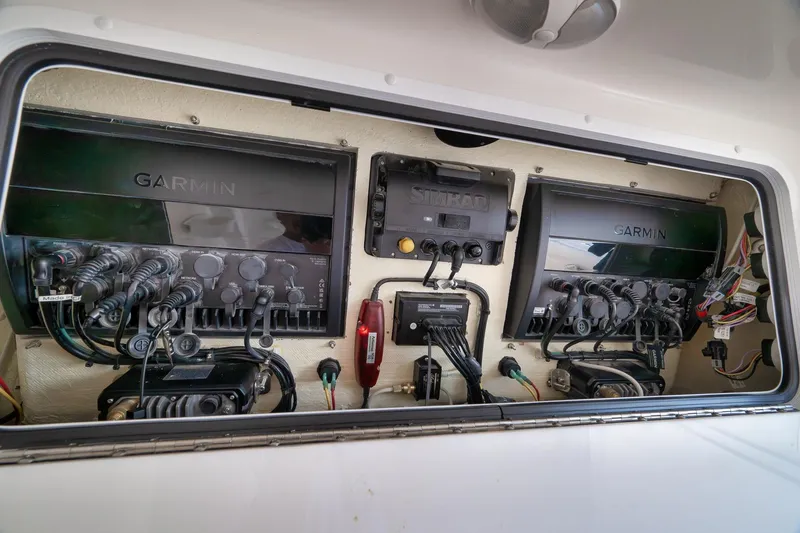 Slide: The Image of 2022 Invincible 39 Open Fisherman electronics panel with Garmin and Simrad systems. - 29