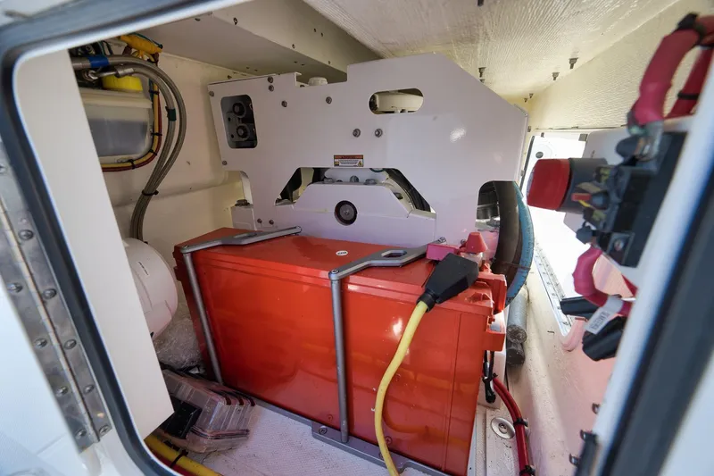 Slide: The Image of 2022 Invincible 39 Open Fisherman boat engine compartment with red battery and wiring. - 30
