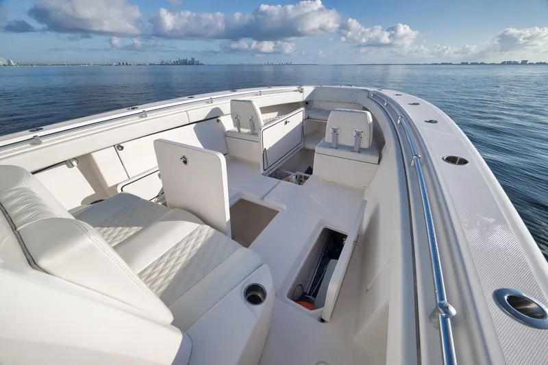 Slide: The Image of 2022 Invincible 39 Open Fisherman boat interior with white seating, ocean view, and clear sky. - 36