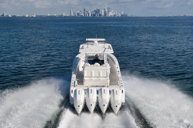Slide: The Image of 2022 Invincible 39 Open Fisherman boat cruising with city skyline in background. - 7