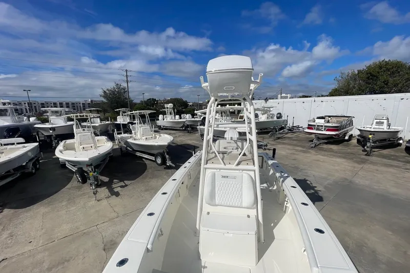 Slide: The Image of 2026 Pathfinder 2400 Open boat displayed in a marina under a clear blue sky. - 11
