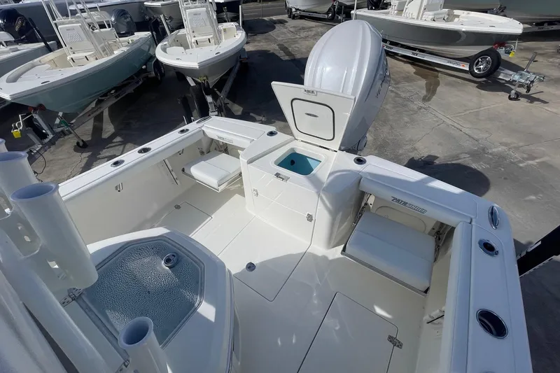 Slide: The Image of 2026 Pathfinder 2400 Open boat interior with seating and storage, displayed in a showroom. - 7