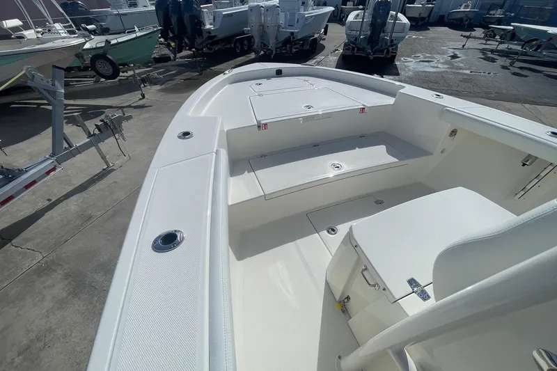 Slide: The Image of 2026 Pathfinder 2400 Open boat interior with seating and storage, displayed outdoors. - 9