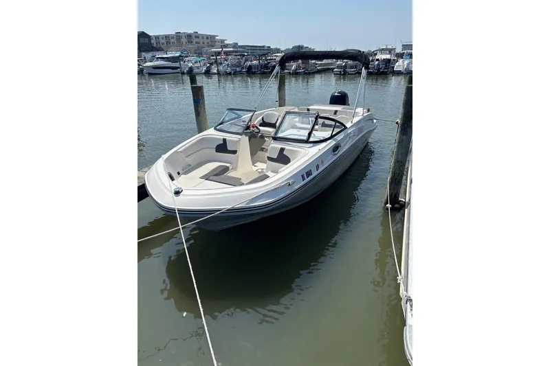The Image of 2024 Bayliner VR6 Bowrider OB docked at marina, sunny day, calm waters. - 1
