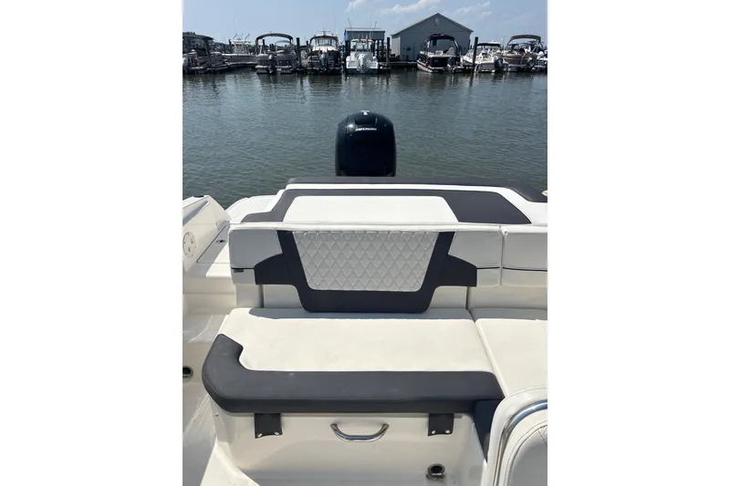 Slide: The Image of 2024 Bayliner VR6 Bowrider OB interior with stylish seating at marina. - 12