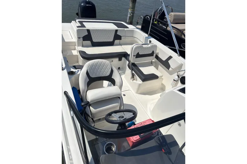 Slide: The Image of 2024 Bayliner VR6 Bowrider OB interior with stylish seating and steering wheel. - 6