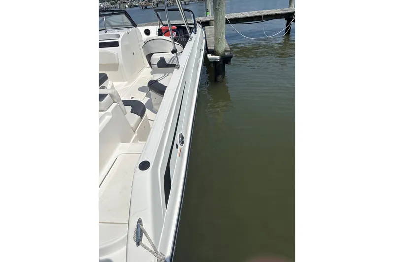 Slide: The Image of 2024 Bayliner VR6 Bowrider OB docked, showcasing sleek interior and seating arrangement. - 9