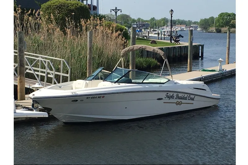 The Image of 2007 Sea Ray 270 SLX boat docked by a scenic waterfront. - 1