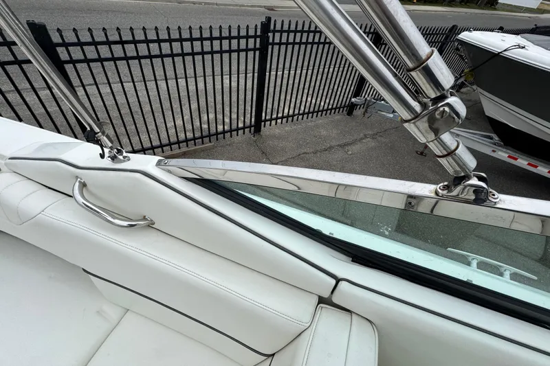Slide: The Image of 2007 Sea Ray 270 SLX boat interior with stainless steel fittings and white upholstery. - 10