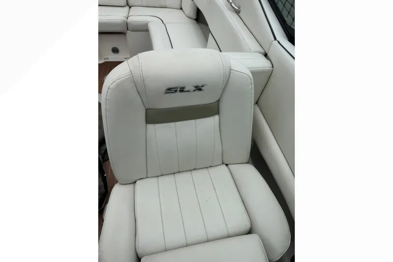 Slide: The Image of 2007 Sea Ray 270 SLX boat seat with white upholstery and SLX logo. - 12