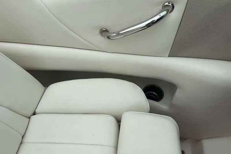 Slide: The Image of Interior of 2007 Sea Ray 270 SLX boat with white upholstery and chrome handle. - 13