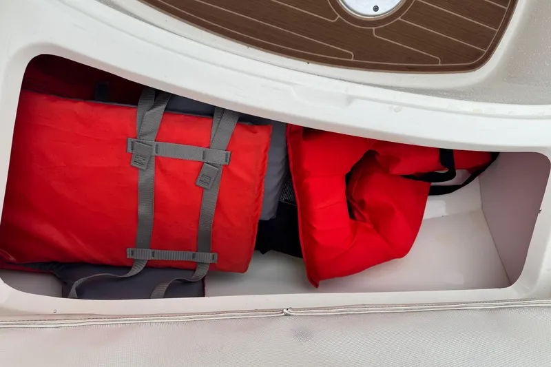 Slide: The Image of Storage compartment in a 2007 Sea Ray 270 SLX boat with red life jackets. - 15