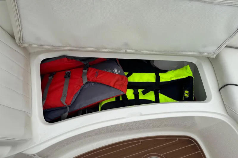 Slide: The Image of Storage compartment on 2007 Sea Ray 270 SLX boat with life jackets inside. - 16